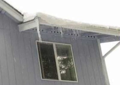 Photo of ice dam in house gutters